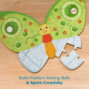 A butterfly-shaped puzzle on a wooden surface with colorful wings and text below reading 